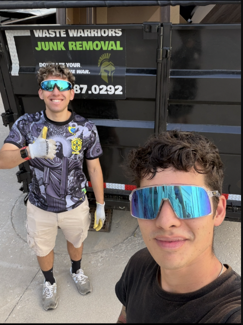 Waste Warriors crew in front of branded trailer