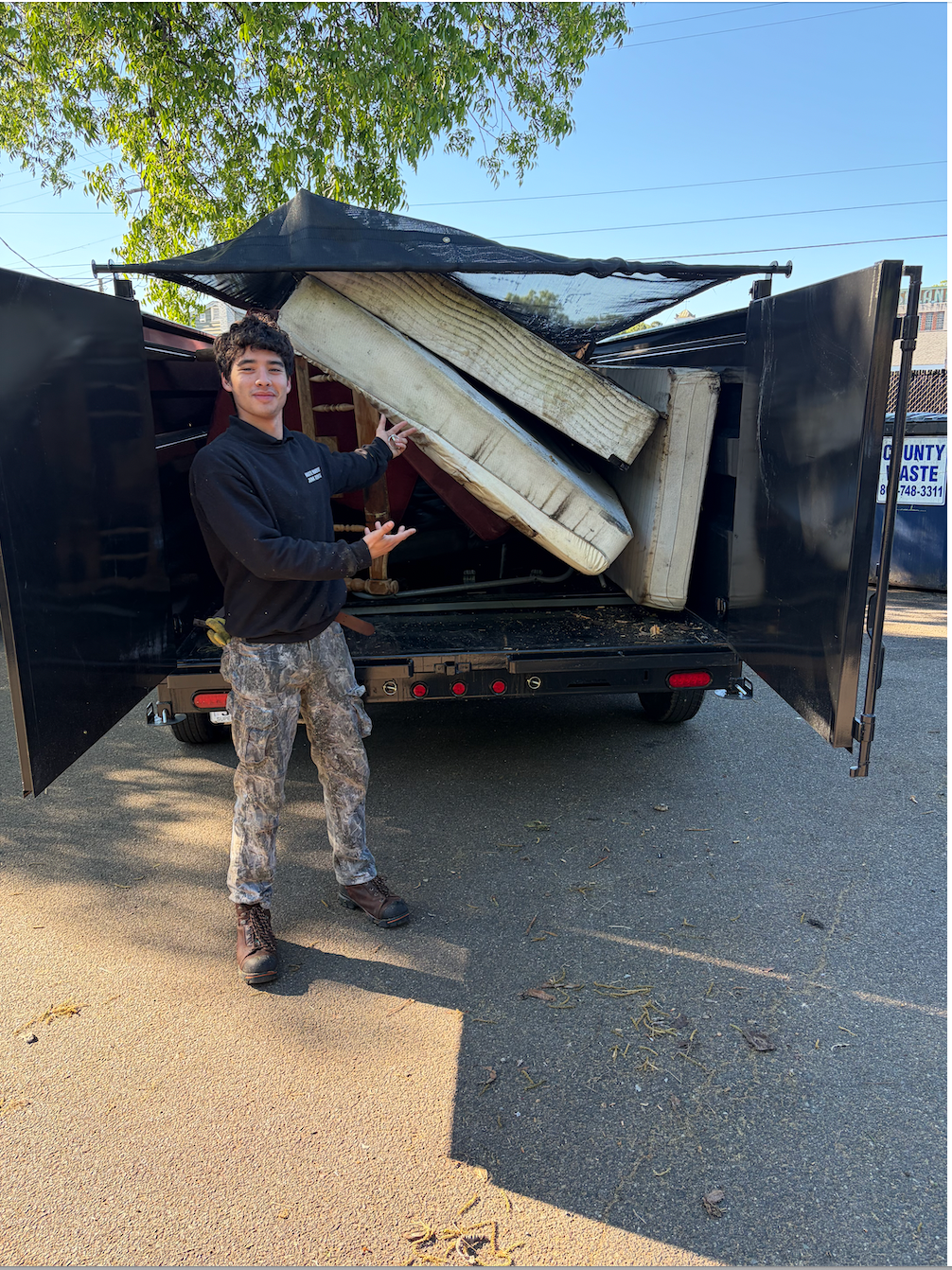 Trailer loaded with bulky junk and mattresses
